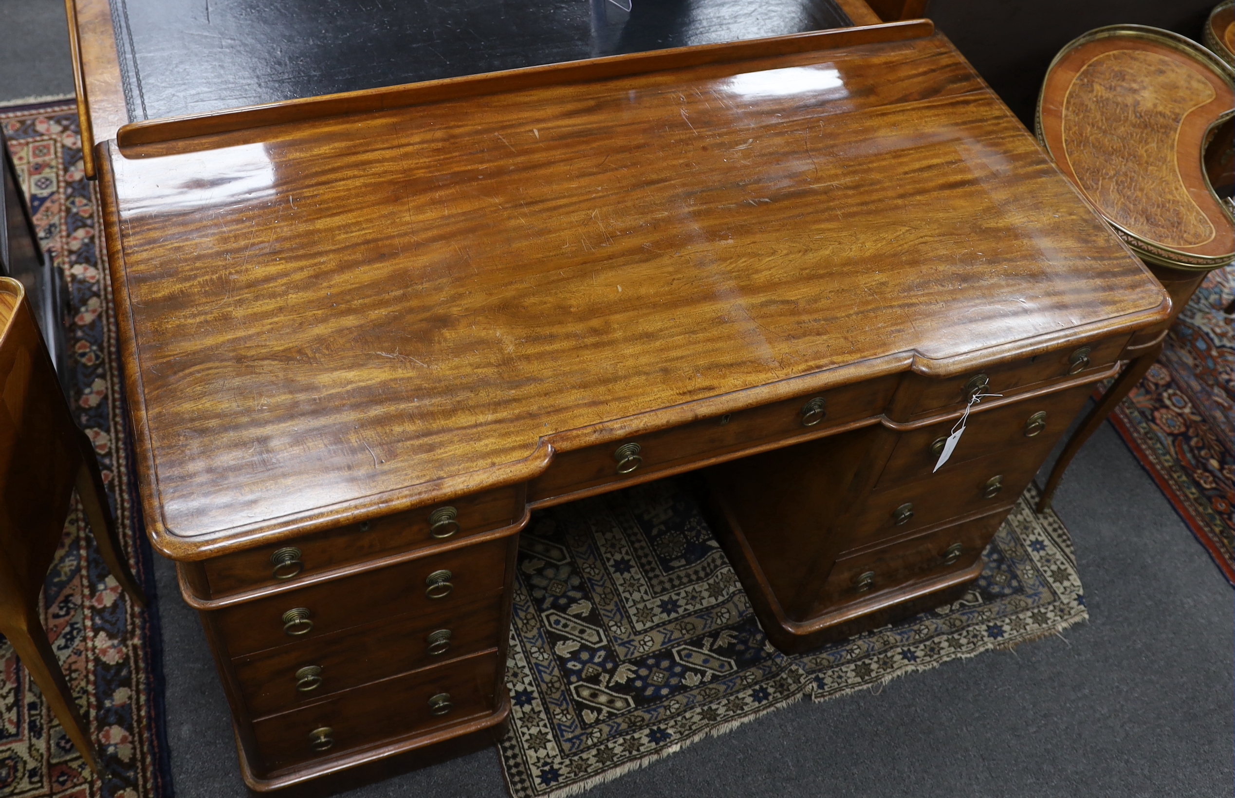 A Victorian mahogany Heal & Son, London inverse breakfront pedestal desk, width 122cm, depth 59cm, height 76cm